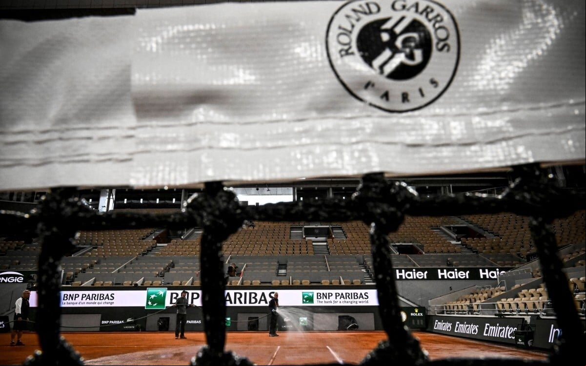 Funcionários dão últimos ajustes na quadra central de Roland Garros, que começa no domingo (Foto: JULIEN DE ROSA / AFP)