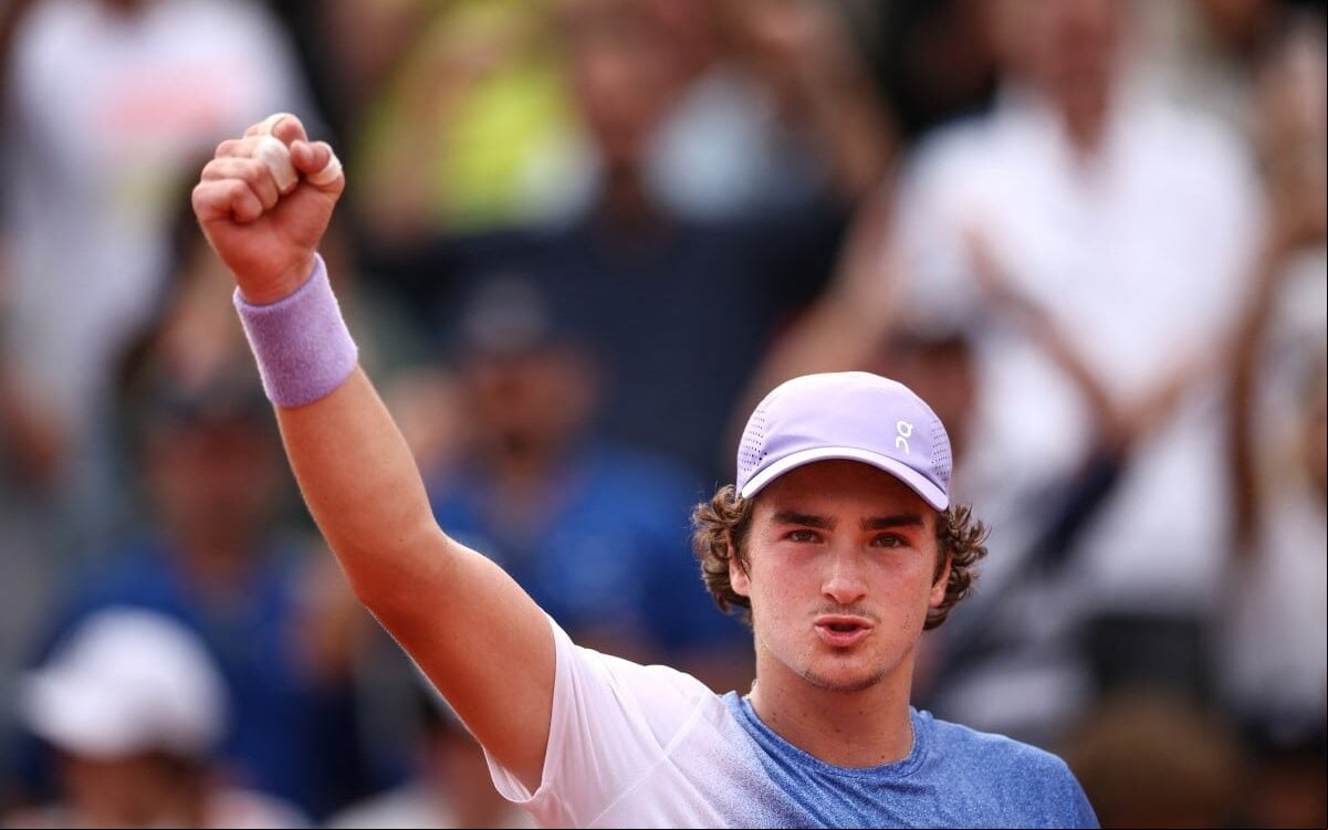 João Fonseca comemora a vitória sobre o francês Pierre-Hugues Herbert em Roland Garros (Foto: Anne-Christine POUJOULAT / AFP)