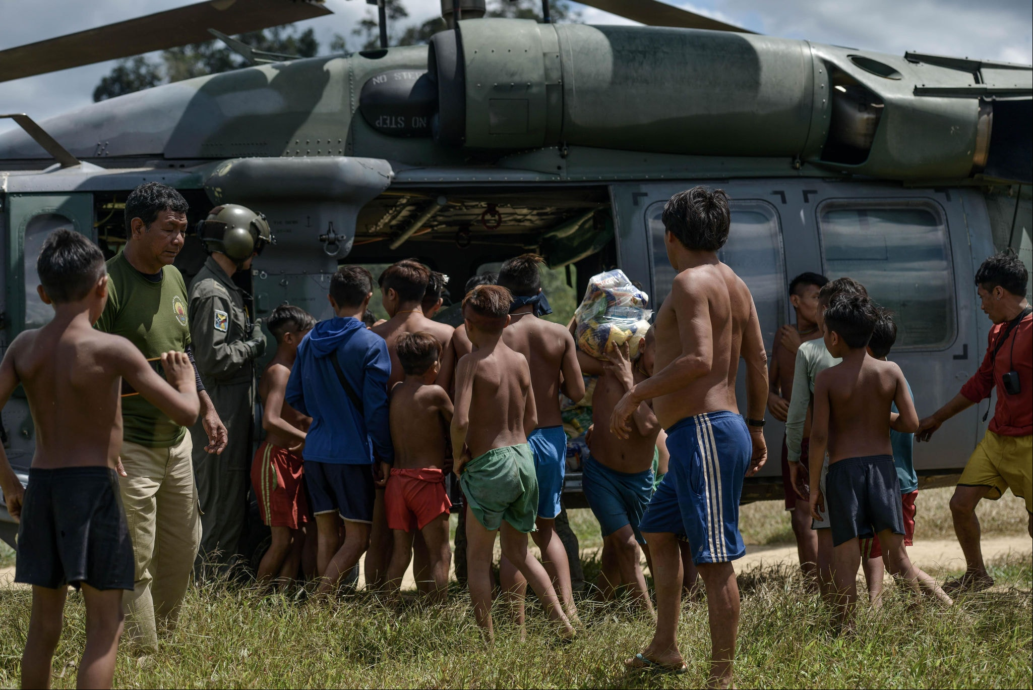 Especial Yanomami Dezenas de indígenas se aproximam de helicóptero para receber cestas básicas: expansão do do garimpo gerou cenário de fome. Fotos: Fred Magno/O Tempo